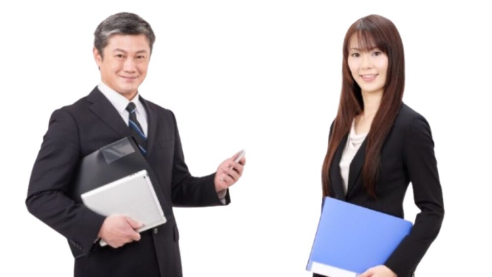 A photo of male and female funeral directors in suits smiling with documents in hand.