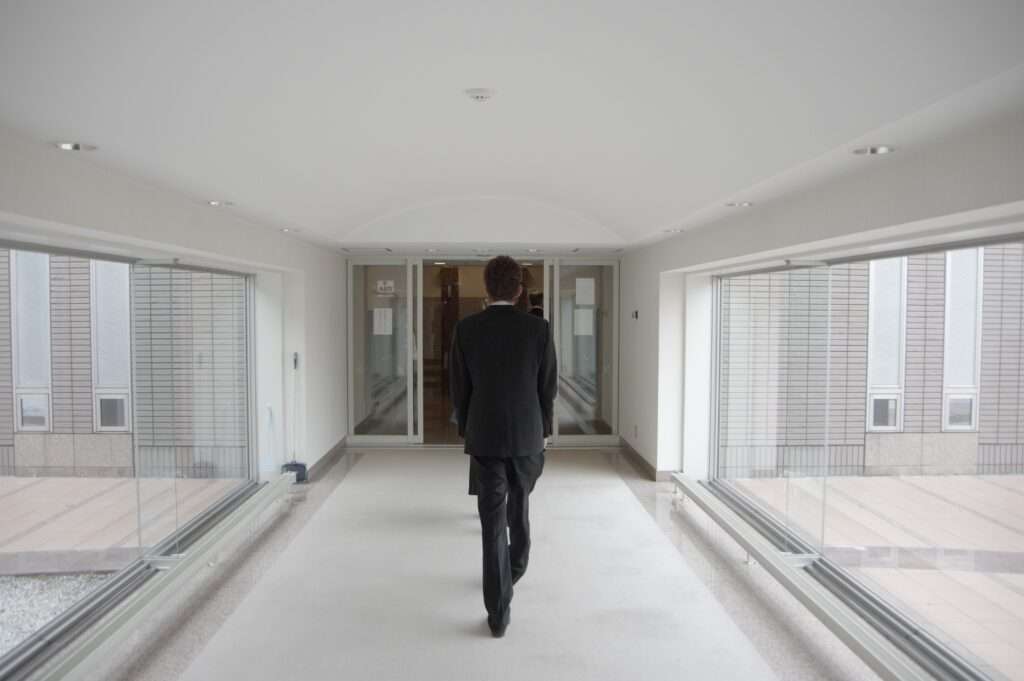 Funeral director carrying a coffin at the crematorium