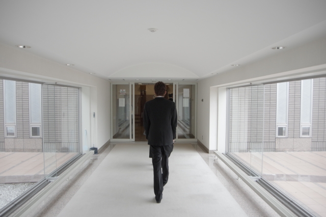 Funeral director carrying a coffin at the crematorium