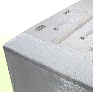 Upholstered and decorated coffin.
