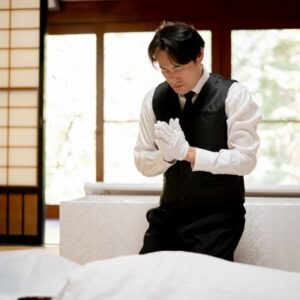 A funeral director who prepares and dresses a corpse
