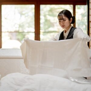 A funeral director who prepares and dresses a corpse
