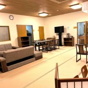 Sofa and dining table set in the family waiting room at Komorebi Funeral Hall