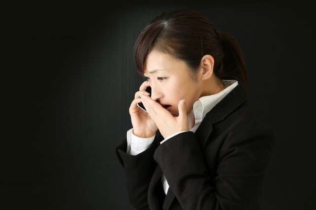 A woman is upset after receiving a sudden phone call with news of a death.